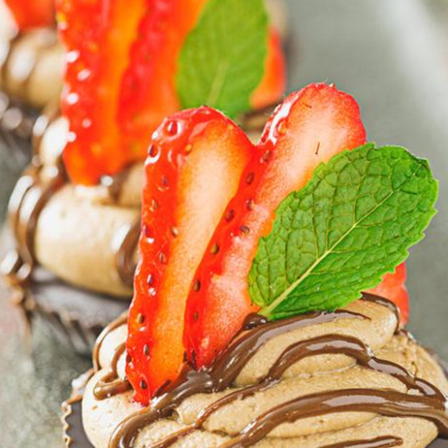 Sun Cups topped with Sun-tella Frosting and Strawberry Slices