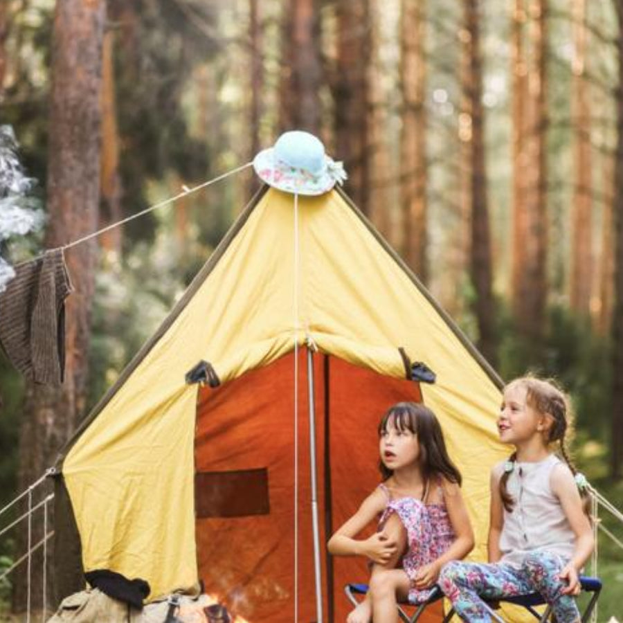 Group of Kids talking in front of yellow tent