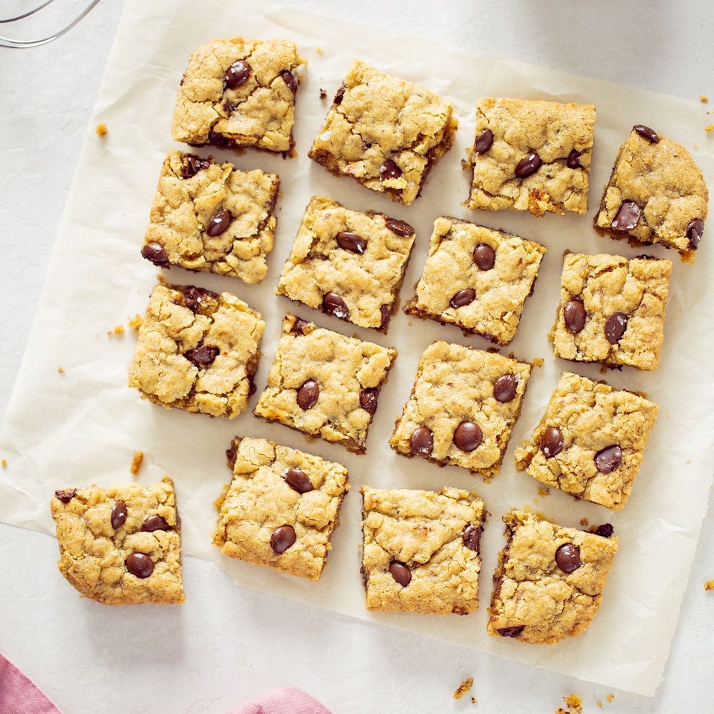 Gluten Free Chocolate Chip Blondie Squares on parchment paper