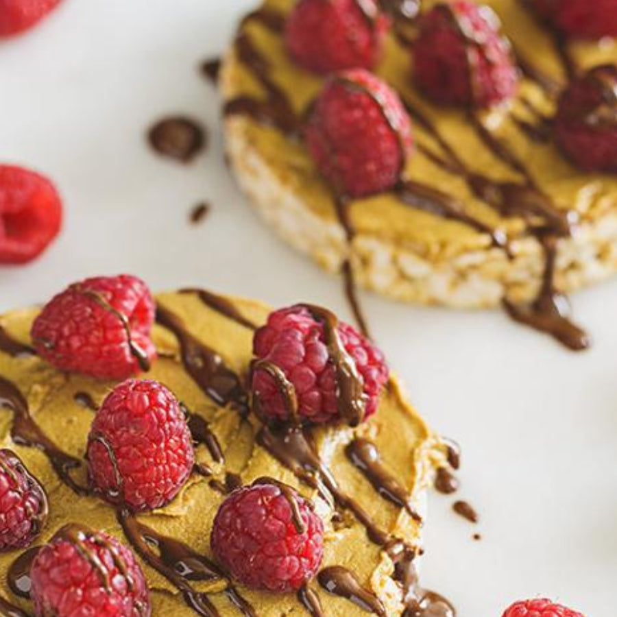 Cinnamon Rice Cakes Topped with Sun Butter, Drizzled Chocolate and Fresh Raspberries