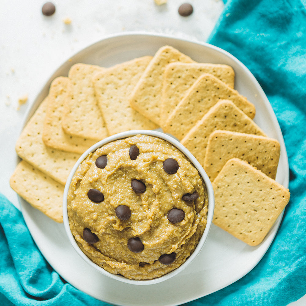 Bowl of Sunflower Chocolate Chip Hummus Dip with graham crackers for dipping