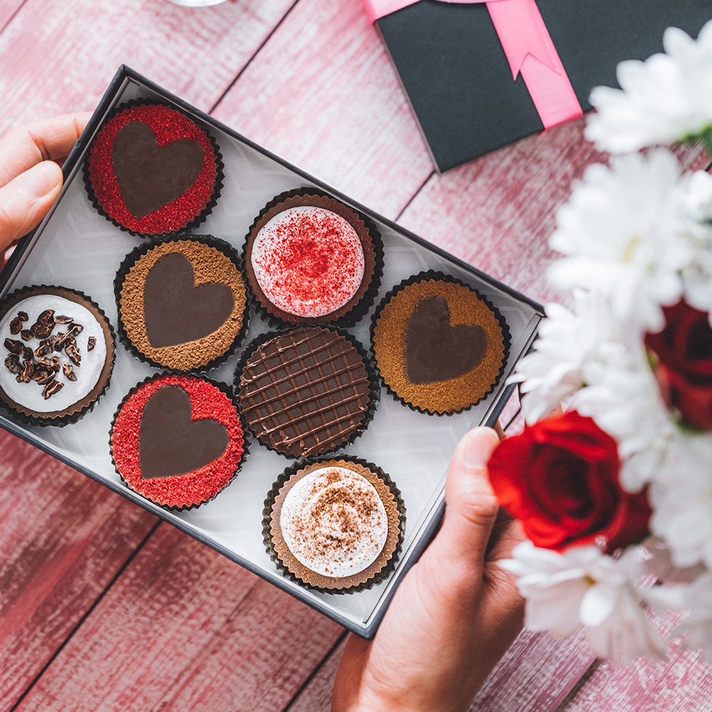 Sun Cups Decorated with Ground Freeze-dried Raspberries, Cocoa Powder and Frosting to Make Valentine's Day Treats