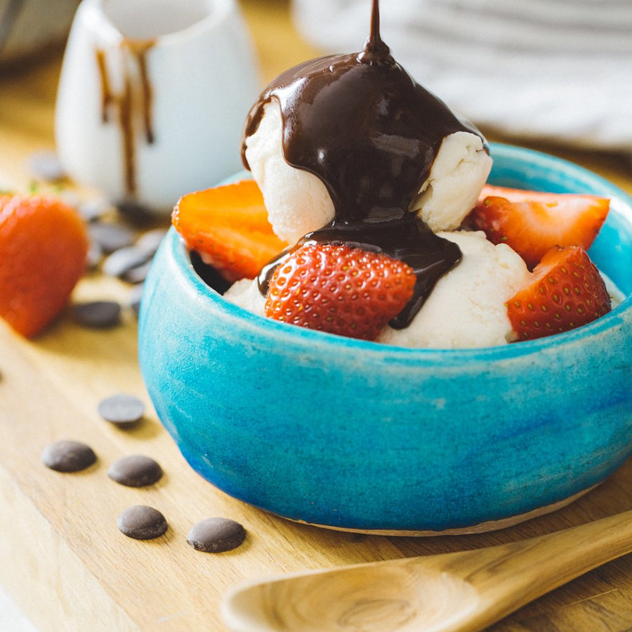 Mexican Hot Fudge Sauce being Poured on Ice Cream and Strawberries