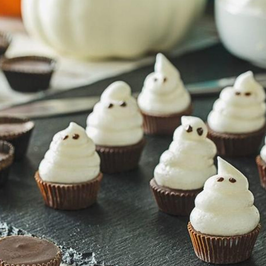 Sun Cups Minis Topped With Frosting, Decorated to Appear Like Little Ghosts