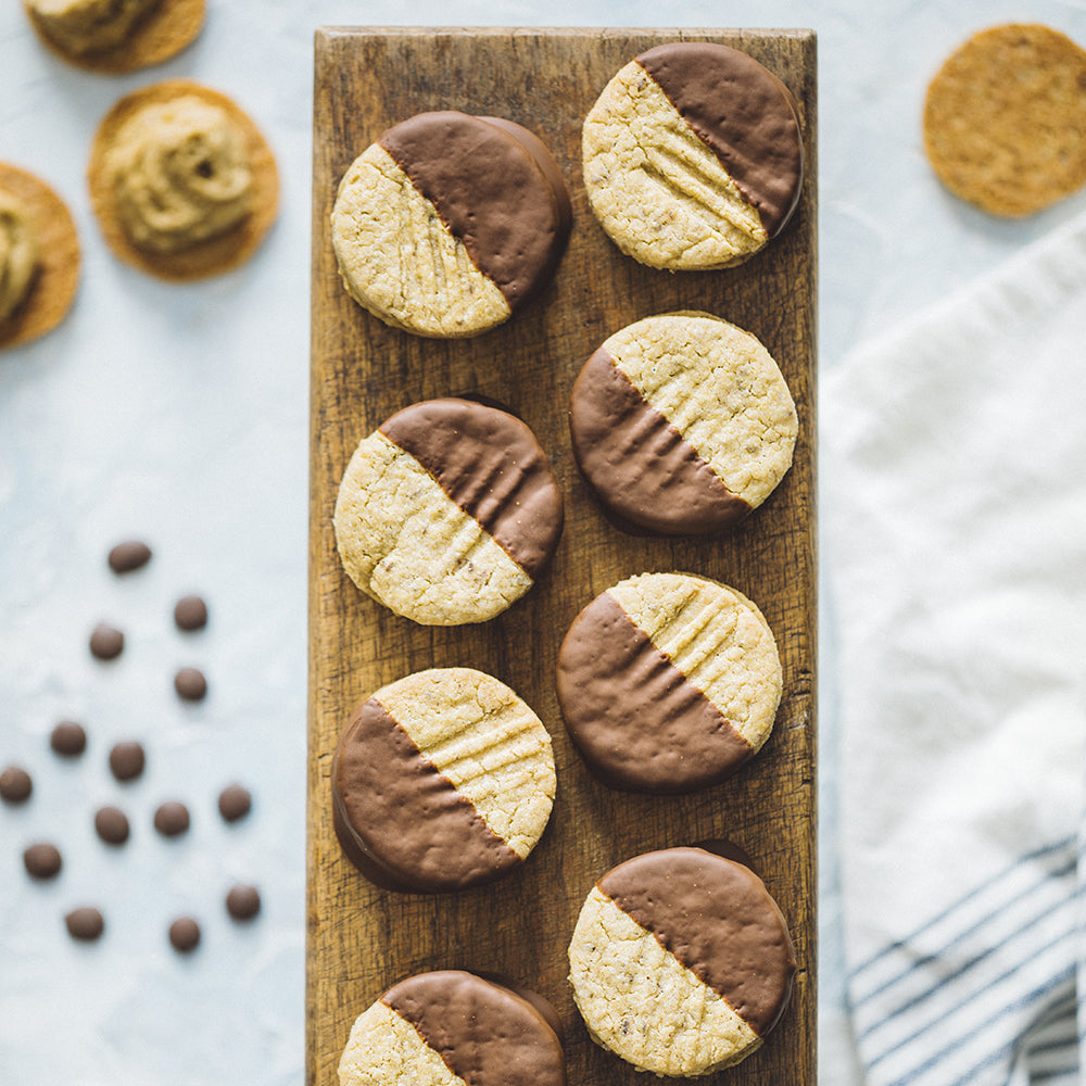 Chocolate Dipped Homemade Sunflower Butter Buddies on Wooden Cutting Board