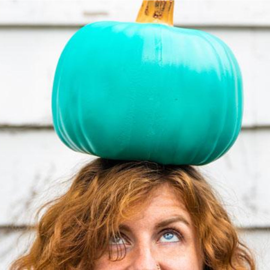 Teal Colored Pumpkin Balanced on Woman's Head